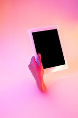 Image showing Close up female hand gesturing from the milk bath with soft glowing in neon light