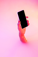 Image showing Close up female hand gesturing from the milk bath with soft glowing in neon light