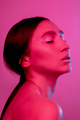 Image showing Beautiful east woman portrait isolated on pink studio background in neon light, monochrome