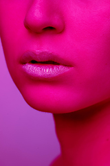 Image showing Beautiful east woman portrait isolated on pink studio background in neon light, monochrome