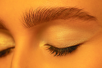 Image showing Beautiful east woman close up portrait in golden colored neon light, monochrome