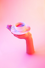 Image showing Close up female hand gesturing from the milk bath with soft glowing in neon light