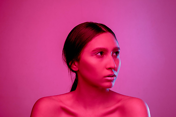 Image showing Beautiful east woman portrait isolated on pink studio background in neon light, monochrome