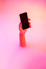 Image showing Close up female hand gesturing from the milk bath with soft glowing in neon light