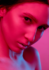 Image showing Beautiful east woman portrait isolated on pink studio background in neon light, monochrome