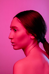 Image showing Beautiful east woman portrait isolated on pink studio background in neon light, monochrome