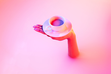 Image showing Close up female hand gesturing from the milk bath with soft glowing in neon light