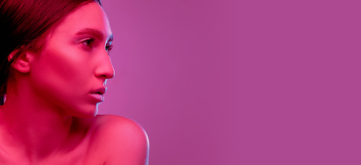 Image showing Beautiful east woman portrait isolated on pink studio background in neon light, monochrome