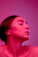 Image showing Beautiful east woman portrait isolated on pink studio background in neon light, monochrome