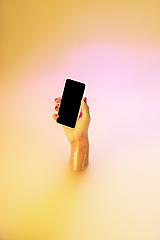 Image showing Close up female hand gesturing from the milk bath with soft glowing in neon light