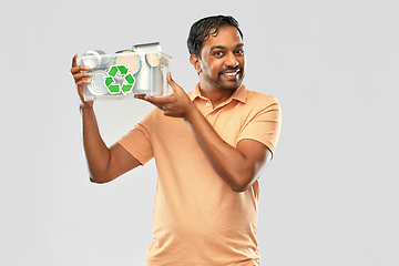 Image showing smiling young indian man sorting metallic waste