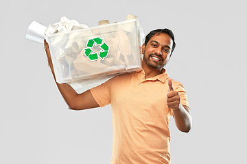 Image showing smiling young indian man sorting paper waste