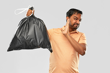 Image showing indian man holding stinky trash bag