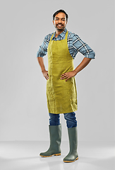 Image showing happy indian male gardener or farmer in apron