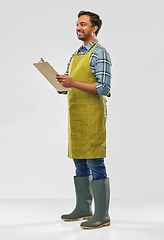 Image showing happy indian gardener or farmer with clipboard