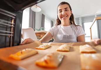 Image showing woman cooking food in oven at home kitchen