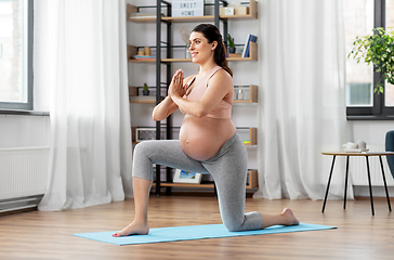 Image showing happy pregnant woman doing sports at home