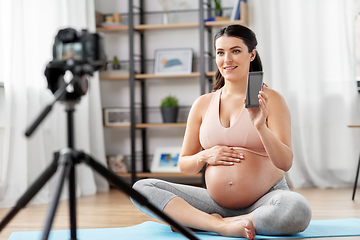 Image showing happy pregnant woman blogger recording yoga video