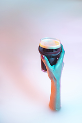 Image showing Close up female hand gesturing from the milk bath with soft glowing in neon light