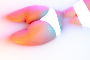 Image showing Close up female body in the milk bath with soft glowing in neon light