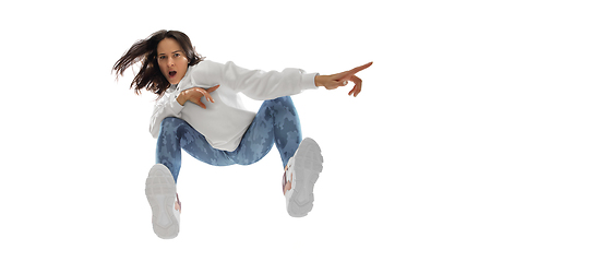 Image showing Young stylish woman in modern street style outfit isolated on white background, shot from the bottom