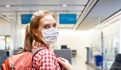Image showing young woman in mask with backpack at airport