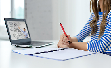 Image showing student girl with exercise book, pen and laptop