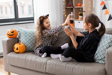 Image showing girls in halloween costumes playing game at home