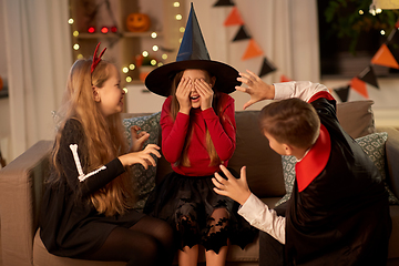 Image showing kids in halloween costumes playing at home