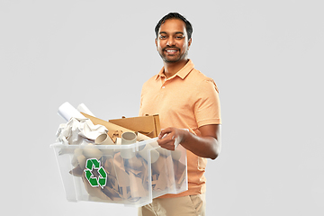 Image showing smiling young indian man sorting paper waste