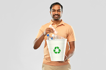 Image showing smiling young indian man sorting plastic waste