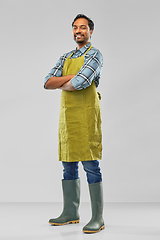 Image showing happy indian male gardener or farmer in apron