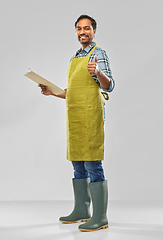 Image showing happy indian gardener or farmer with clipboard