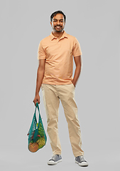 Image showing happy indian man with food in reusable net tote