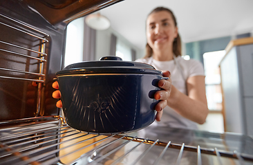Image showing woman cooking food in oven at home kitchen