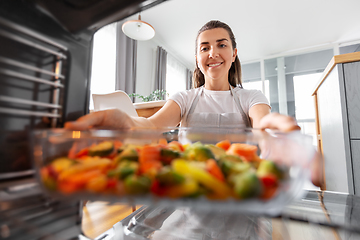 Image showing woman cooking food in oven at home kitchen