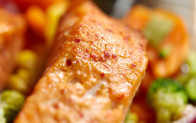 Image showing close up of baked salmon fish with vegetables