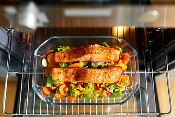 Image showing food cooking in baking dish in oven at home