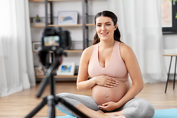 Image showing happy pregnant woman blogger recording yoga video