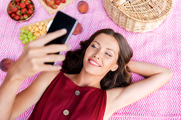 Image showing happy woman with smartphone taking selfie at park