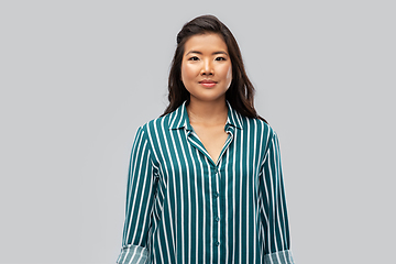 Image showing happy asian woman over grey background