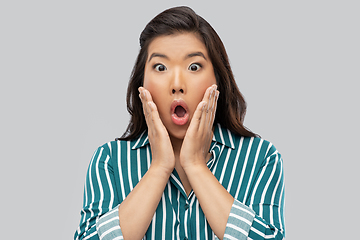 Image showing shocked asian woman over grey background