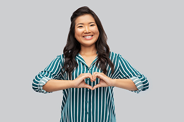 Image showing happy asian woman showing hand heart gesture