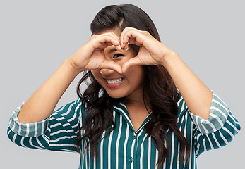 Image showing happy asian woman showing hand heart gesture