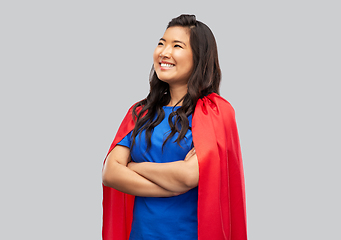 Image showing happy asian woman in red superhero cape