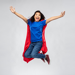 Image showing happy asian woman in red superhero cape jumping