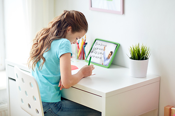 Image showing girl with tablet pc having online lesson at home