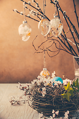 Image showing Nest with Easter eggs and blooming branches with pussy willow branches decorated