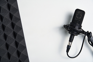 Image showing Black microphone on white background with copy space and acoustic foam panel