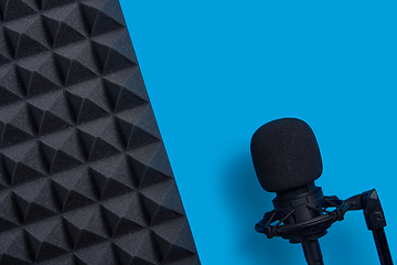 Image showing Flat lay of microphone and acoustic foam panel, over blue background